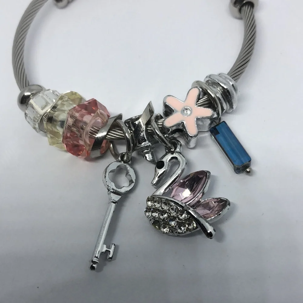 SILVER tone memory coil rope slide and dangle charm bracelet swan key flower.